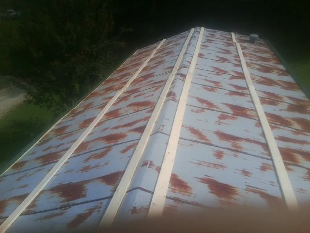 Rusted metal roof panels with new wood purlins before replacement — Storm Damage Roof Repair in High Point by Roofing Brothers